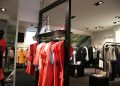 Discover a chic fashion boutique showcasing a variety of colorful clothes on elegant racks.