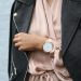 Stylish woman in a leather jacket showcasing an elegant wristwatch, perfect for fashion-forward individuals.