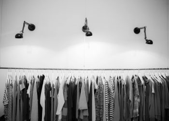 Minimalist black and white clothing display in a stylish boutique setting.