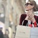 Stylish woman with shopping bags in Galleria Vittorio Emanuele II, Milan.